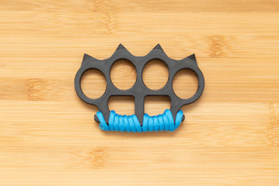 Black Brass Knuckles wrapped in Blue Paracord
