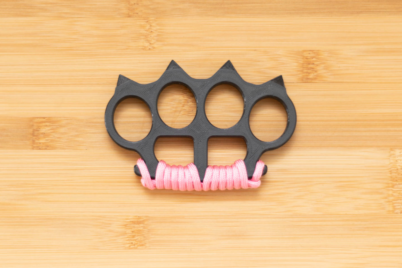 Black Brass Knuckles wrapped in Pink Paracord