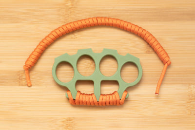 Brass Knuckles with Orange Paracord