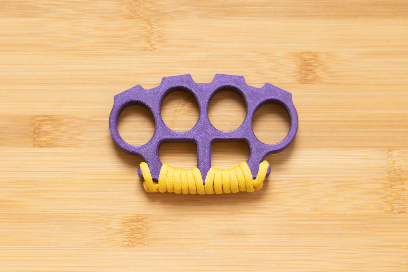 Royal Purple Brass Knuckles wrapped in Yellow Paracord